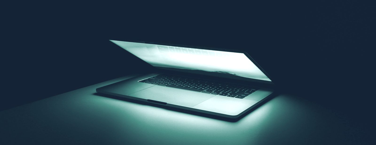 Notebook encendido sobre fondo oscuro, listo para una sesión de soporte remoto